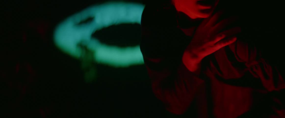 A woman is dancing in front of the lights