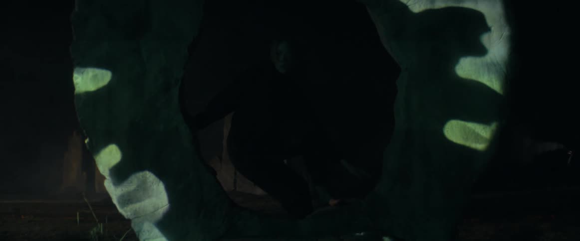 A person is walking in a room during the night