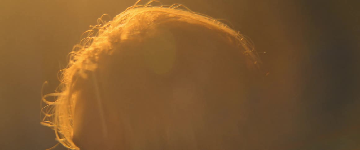 A woman dances under a bright spotlight