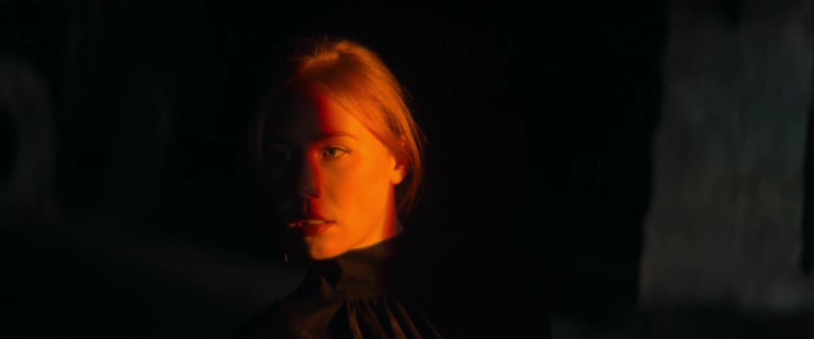 Close up view of a womans face at night is displayed