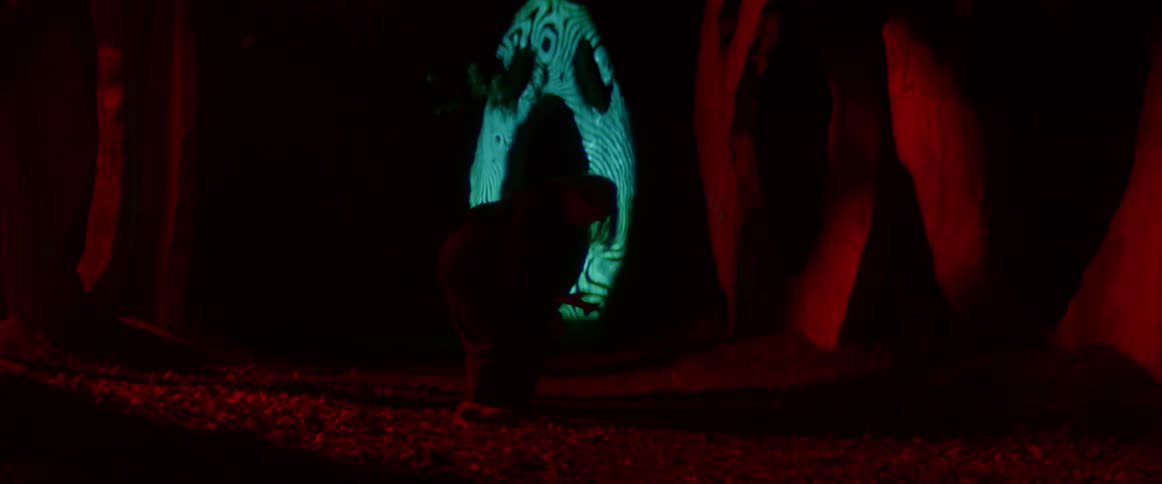 A woman is dancing in front of flashing lights