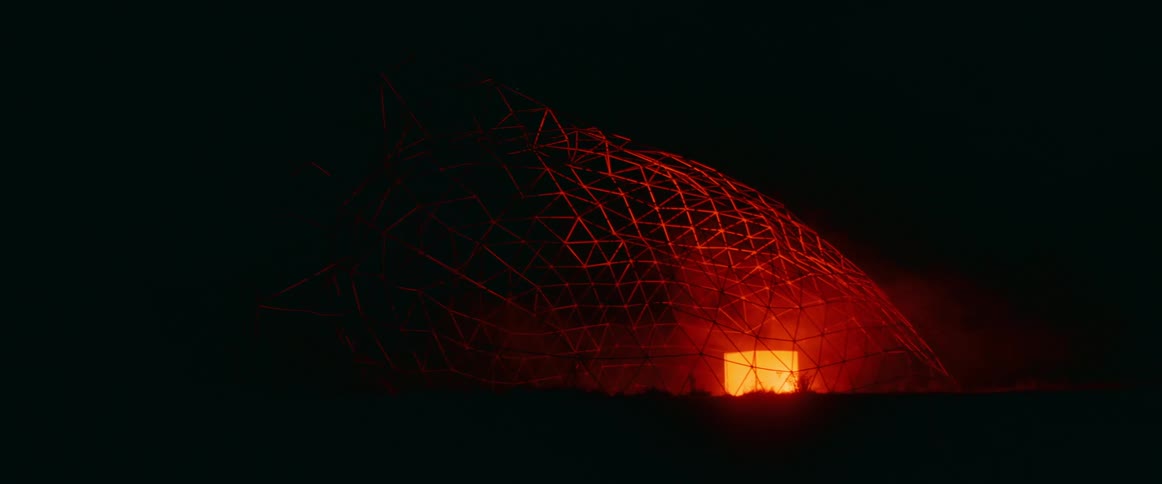 Big dome pipe with a cube of orange light inside surrounded by smoke at night outdoors