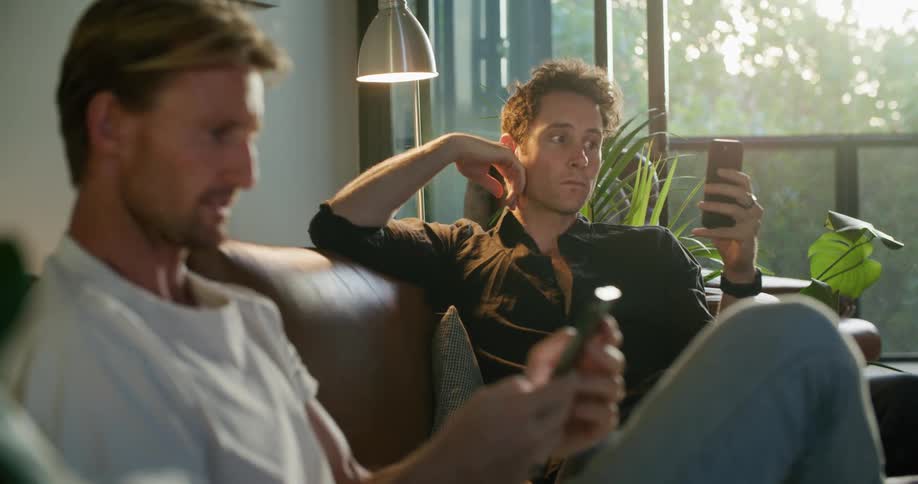 Two friends are on their cell phones and talking to eachother