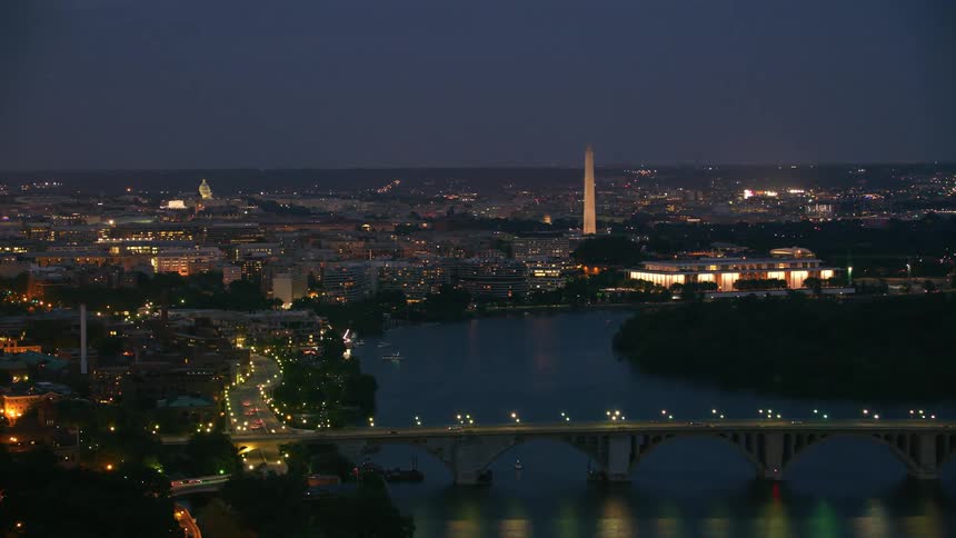 Aerial view of a downtown city at night is displayed