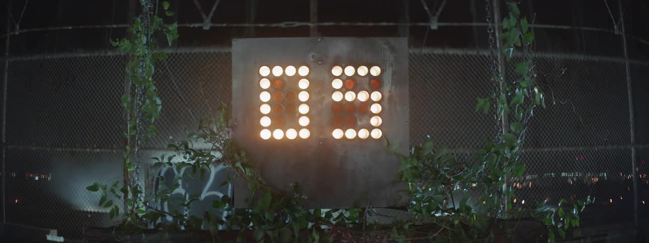 A shot clock is moving numbers at night