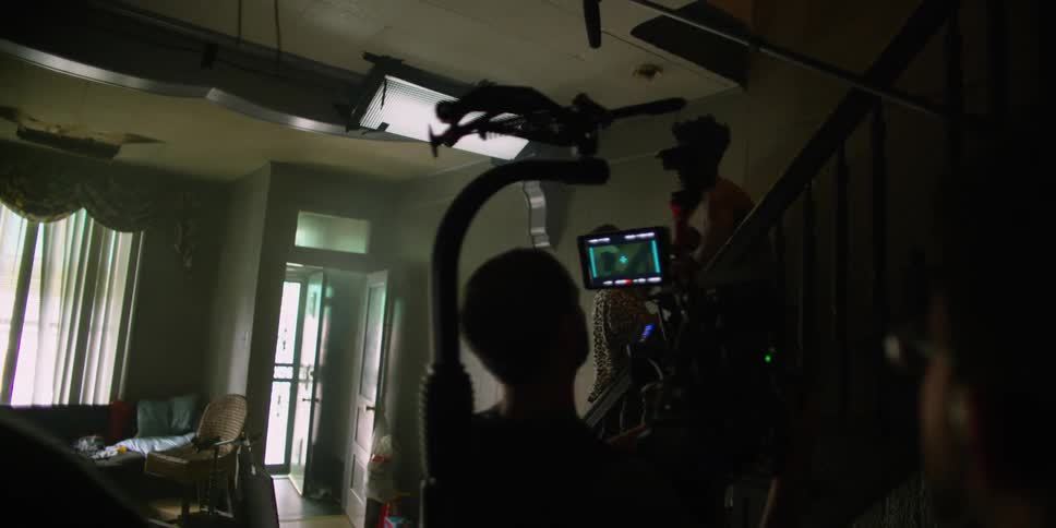 Two people are arguing and being filmed as they go upstairs