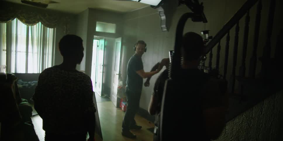 Two people act out a scene as they are being filmed