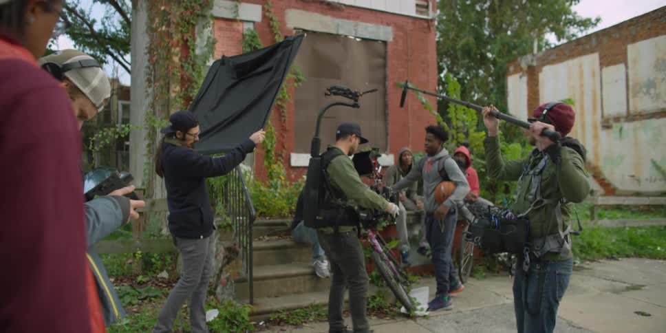 A film crew is filming in front of a home