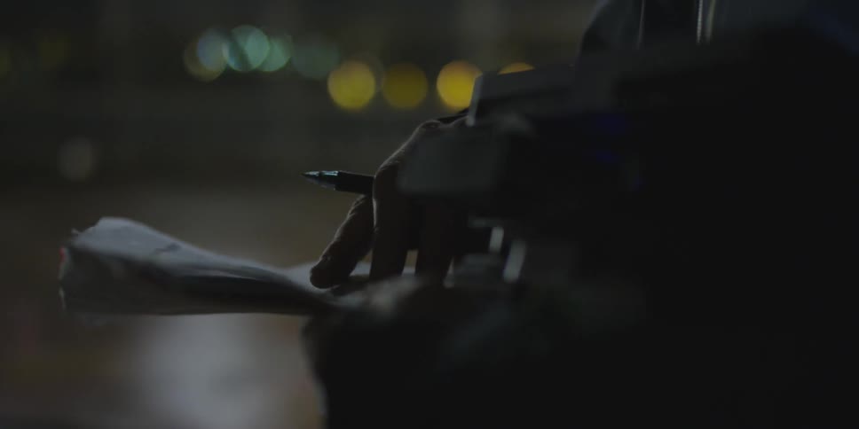 A person examines papers in his hands
