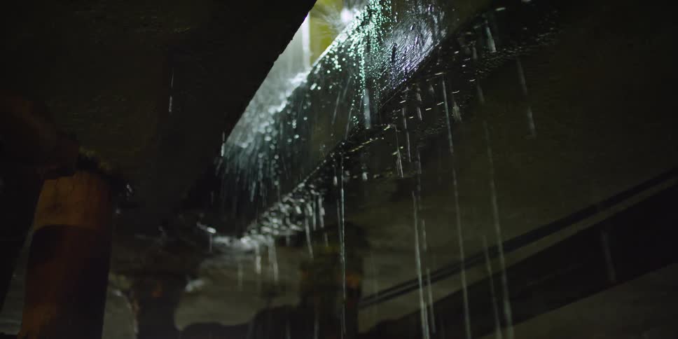 Heavy rain is pouring down through a gap