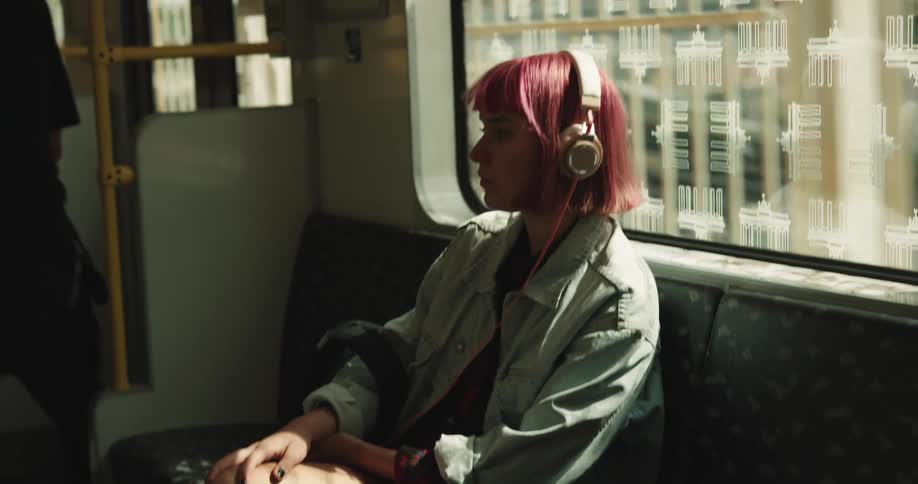 Female passenger on train car standsand moves toward door