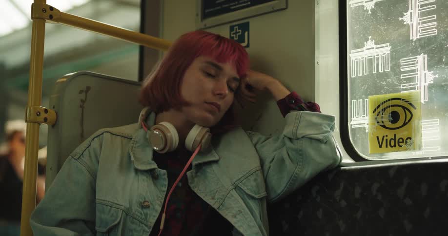 A woman rests as she rides the train