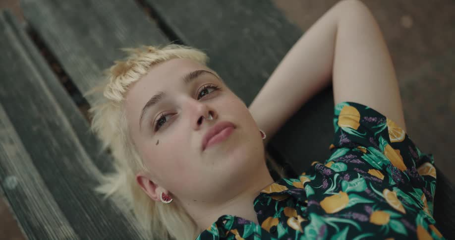 A woman is laying own on a wooden floor