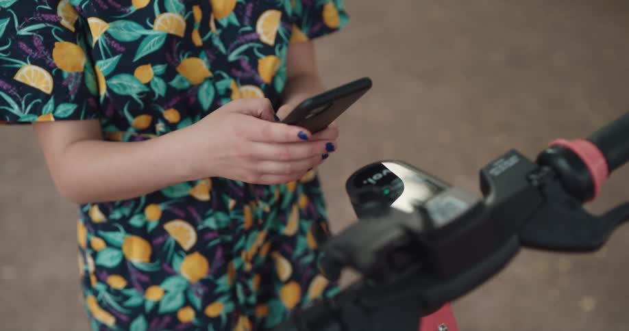 A woman is taking a picture of a bike with her cell phone