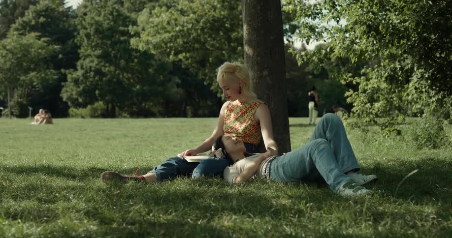 People are laying around in a park enjoying the nice day