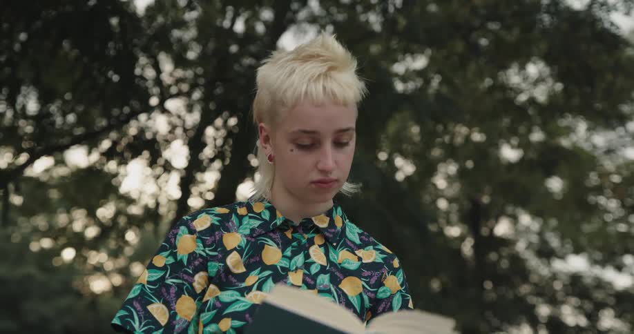 A woman is reading a book outside