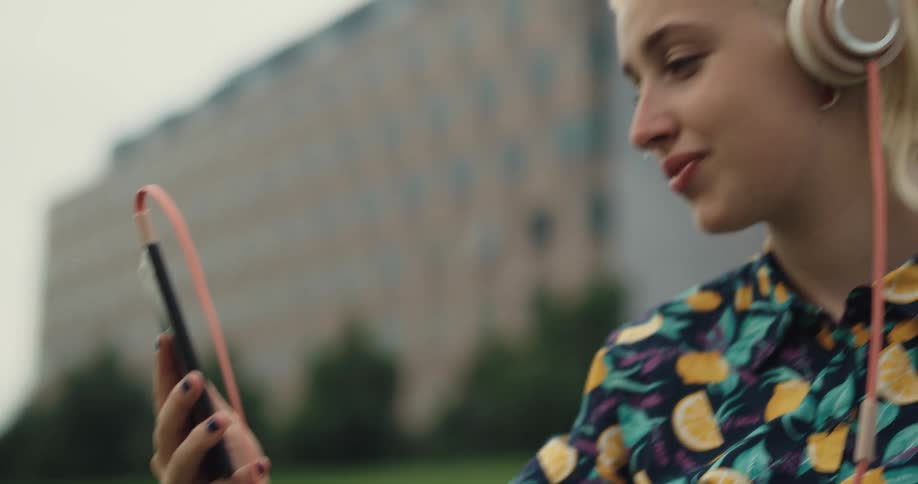 A woman is video chatting with someone on her cell phone