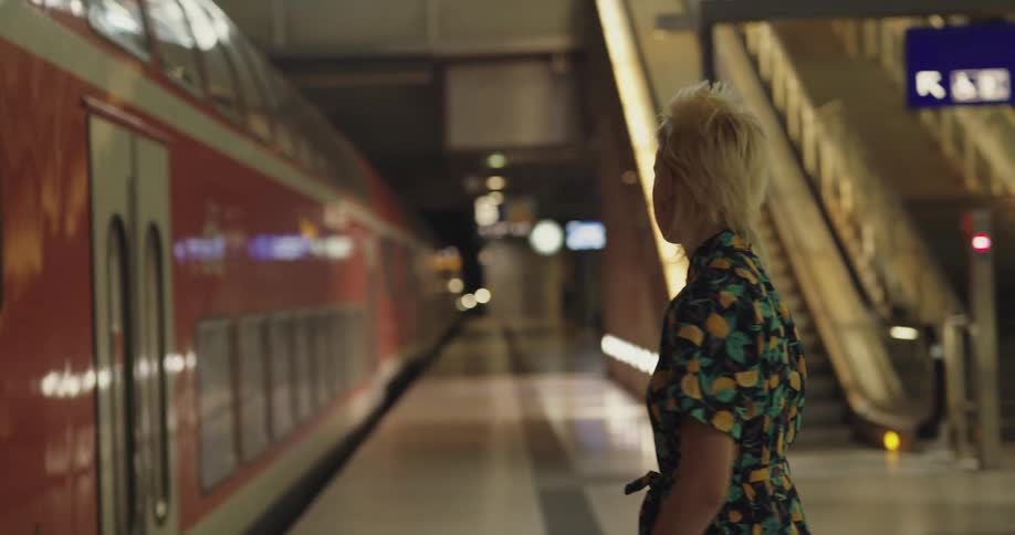 A woman is frustrated when the train leaves the station without her