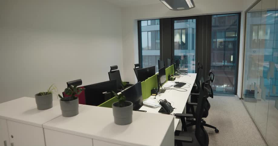 Interior view of office with desks and computers