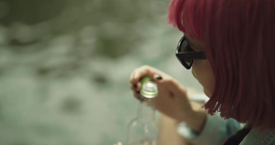 A woman drinks from a water bottle