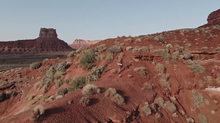 A man hikes up the side of a canyon