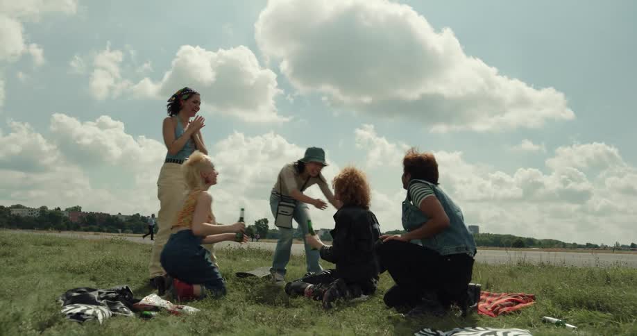 Friends hug and greet at a picnic