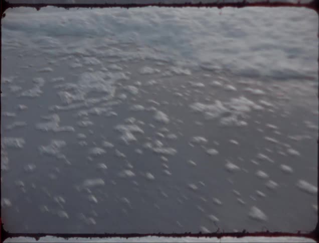 Footage of sea waves moving towards the coast is displayed