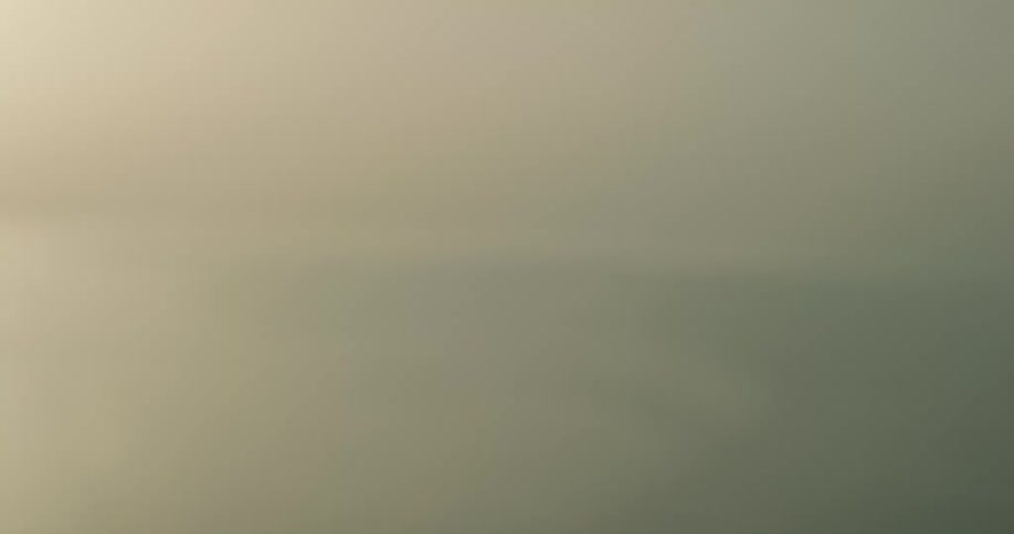 Ashes being thrown up and then falling down over the ocean at evening