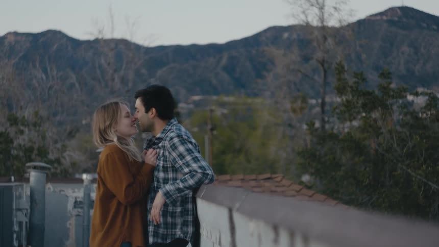 A couple kiss on the roof