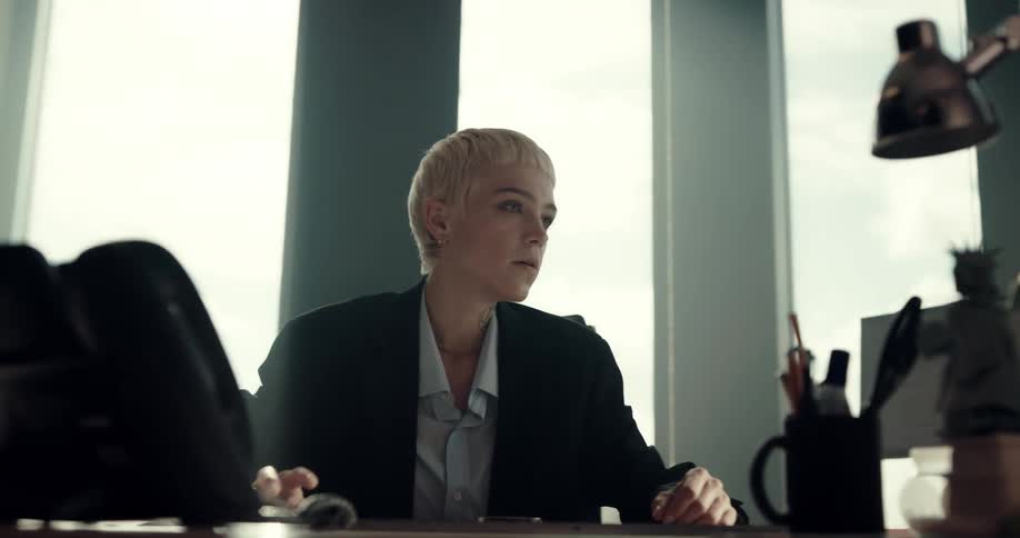 A woman answering a phone in an office