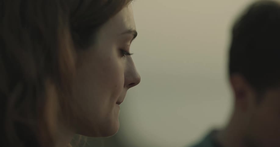 Man and woman are standing outdoors together at dusk