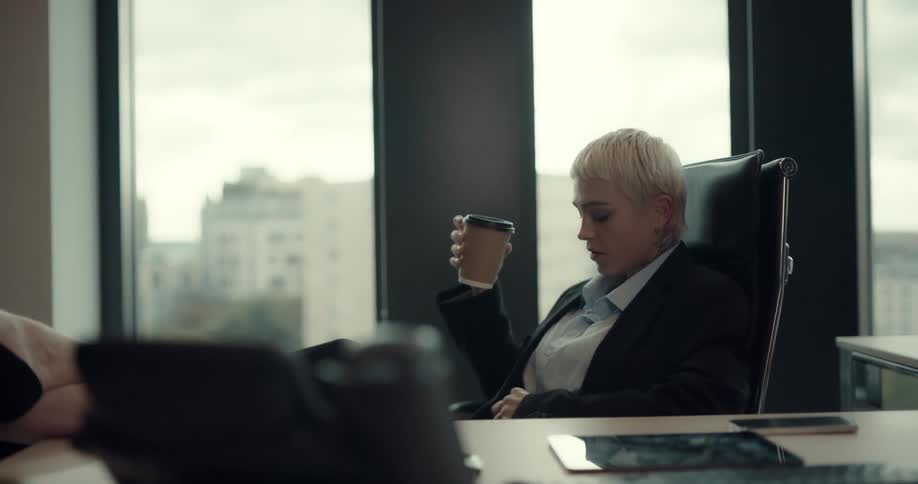 A woman sits in the chair in the office