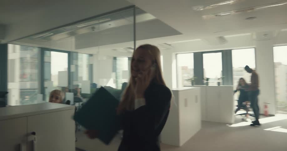 Point of view of a person walking around an office to talk to an employee sitting at a desk
