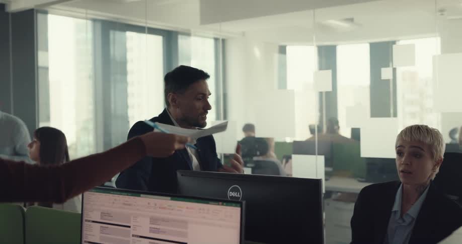After coworker hands more work to overworked employee their boss hand the paperwork back and continues talking to worker regarding problem