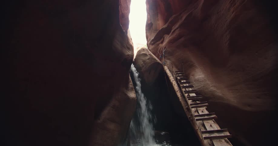 Creek water flows and splashes in the kanarraville falls slot canyon