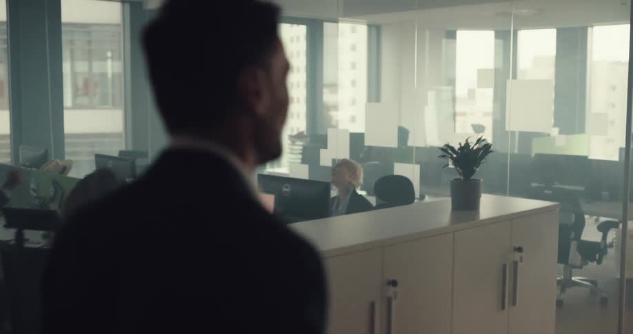 Boss walking on through the office greeting employees