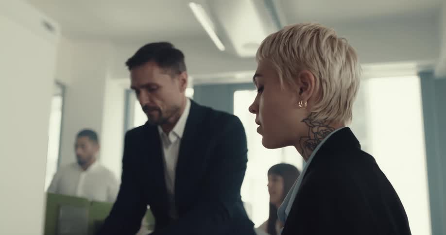 Distressed blonde female being yelled at by her boss at the office