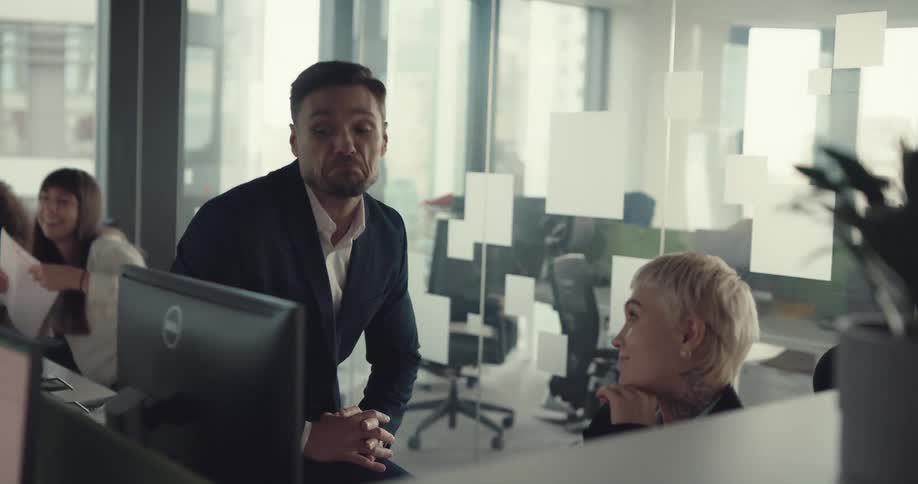 Coworkers talk in the office