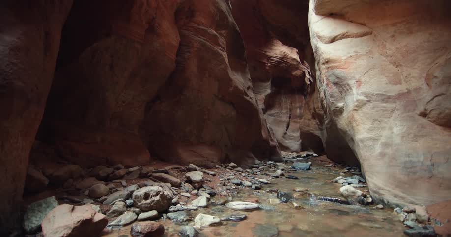 Calm shallow river flowing over the rocks through a canyon