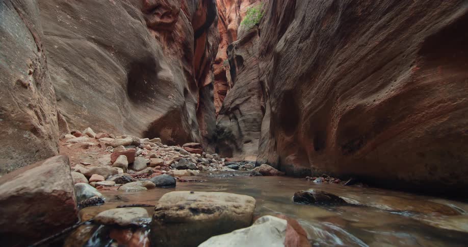 Water flows along stream bed running through canyon