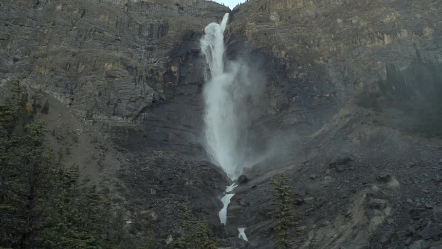 A waterfall is at the center is of this cliffside