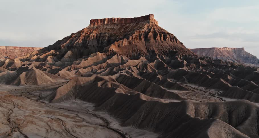 Aerial view of cliffs and valleys is displayed at dusk