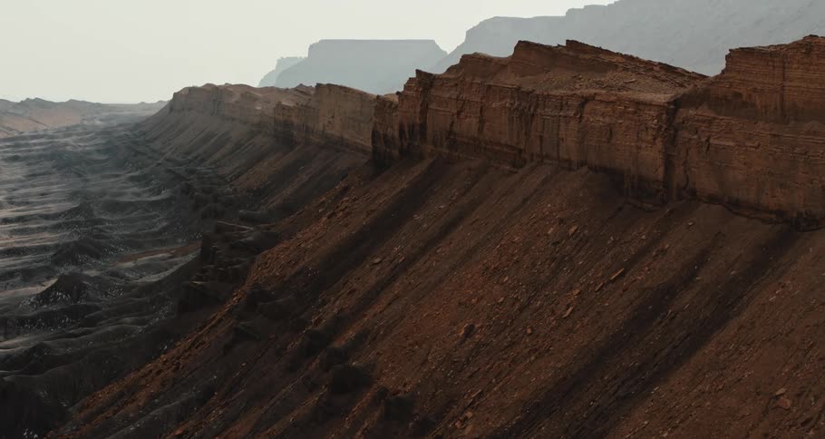 Aerial view of mesa in the desert badlands under a hazy sky