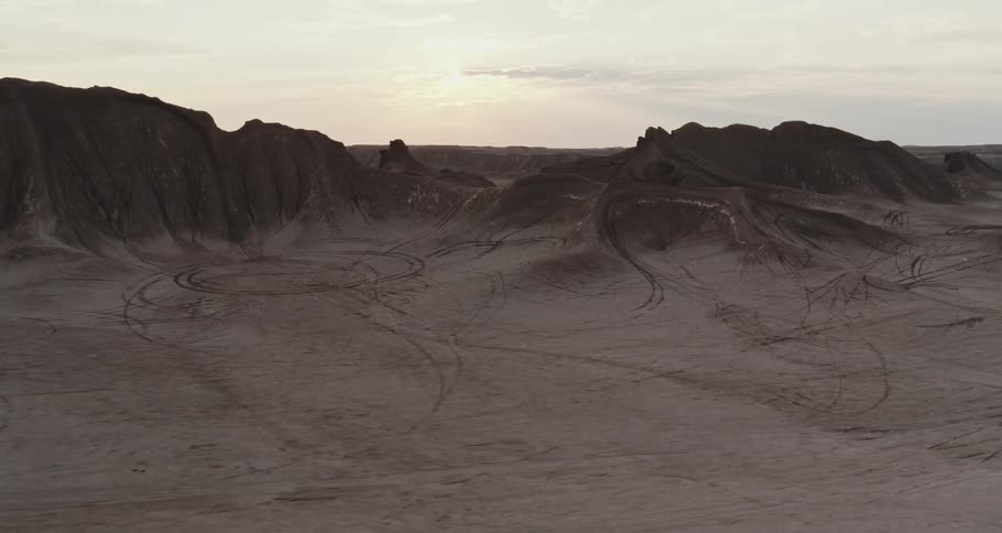 A mountain ridge in the desert under a cloudy sky