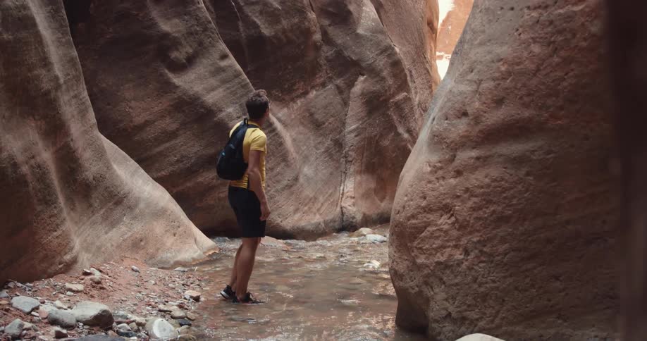 A man is hiking and taking pictures of cliffs