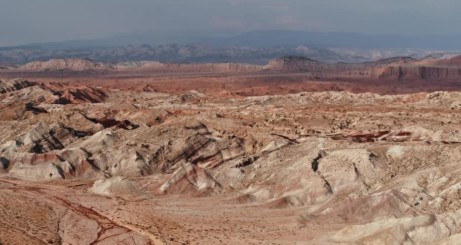 Sand surrounds a butte in a canyon