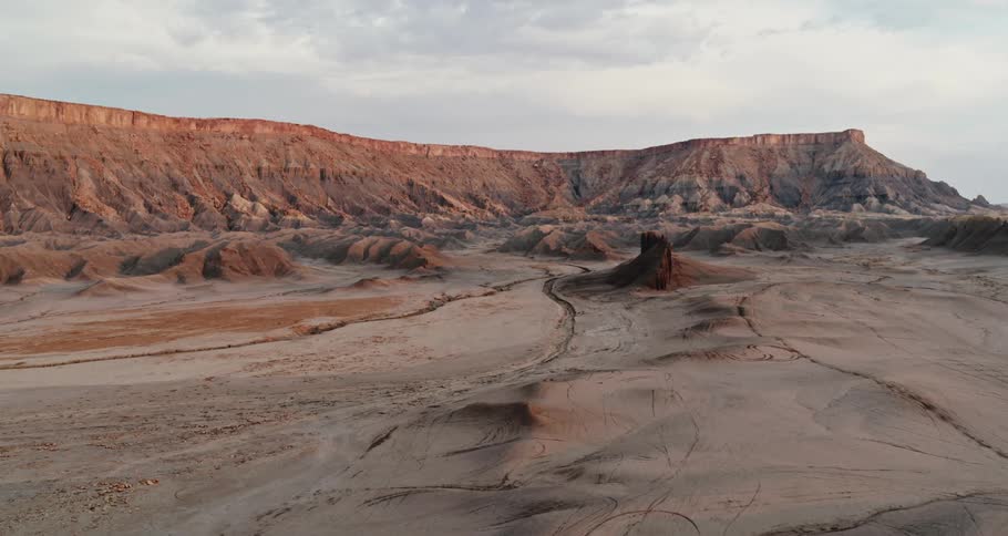 Rock formations in the desert and mesa under a cloudy sky