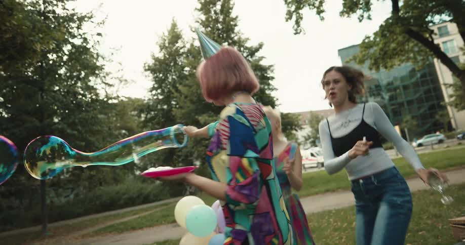 Friends have a birthday party in the park