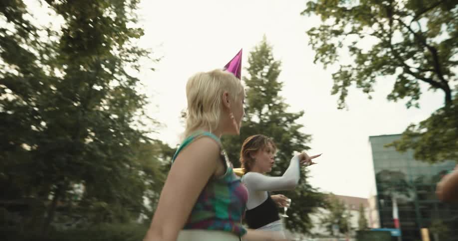 Women celebrate birthday in park with bubbles and balloons