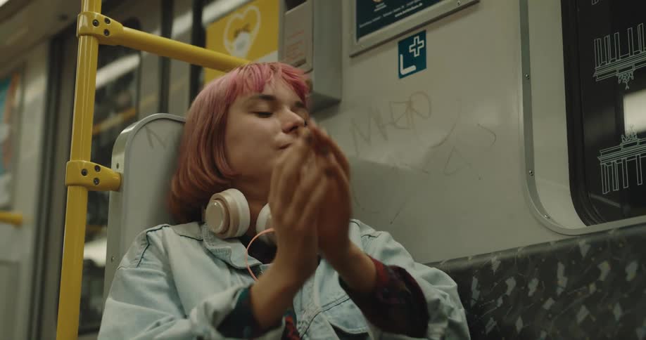 A woman is sitting on a public transportation bus